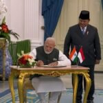 PM Modi signs guestbook upon meeting Indonesian Prez Subianto at Istana Merdeka